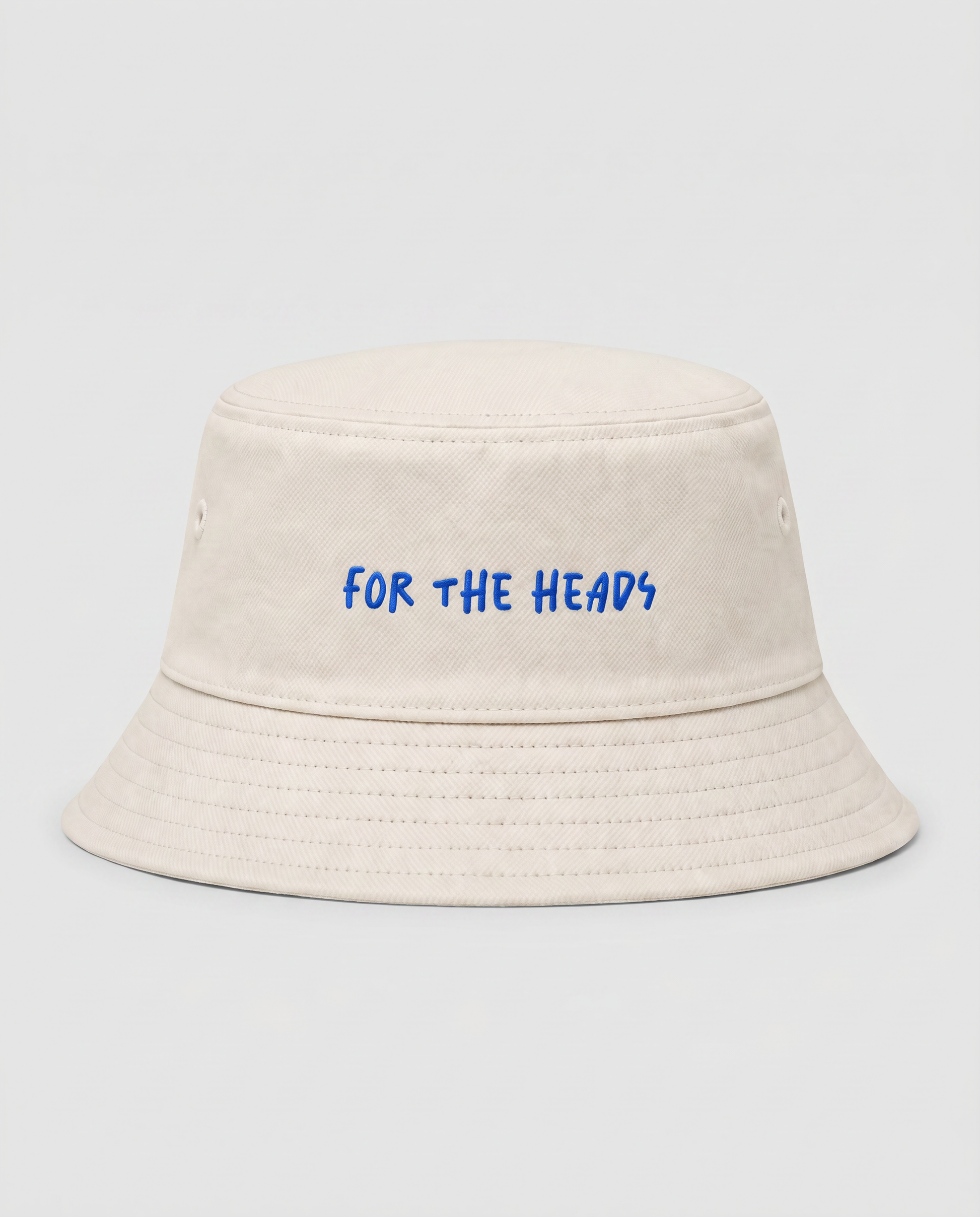 Beige bucket hat with 'FOR THE HEADS' text in blue on a light gray background